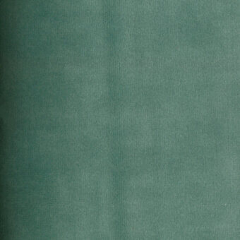 Teal velvet fabric texture with a subtle weave, displaying a matte finish and consistent color, featuring a “turri” brand label.